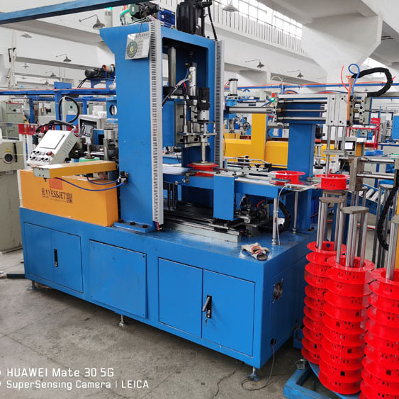 Precision cable coiling machinery operating on a factory floor